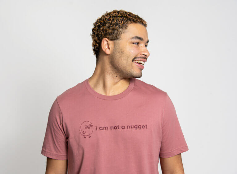 Model smiling off camera wearing an "i am not a nugget" shirt